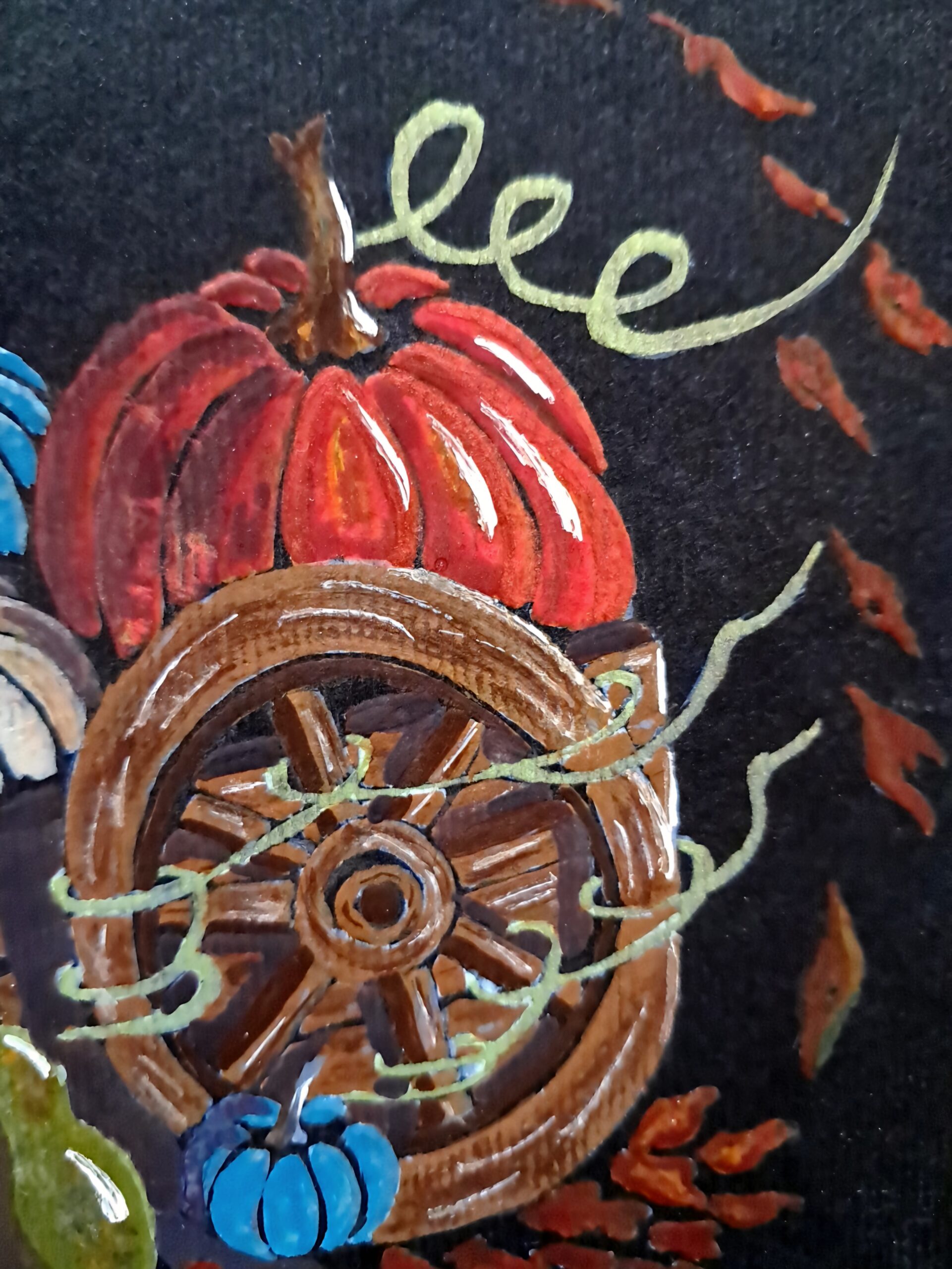 Détail de l'aquarelle originale "Adopt Your Pumpkin" montrant une grosse citrouille orangée, une roue en bois, une petite citrouille bleu de Hongrie, des végétaux et des feuilles d'automne sur papier noir.
